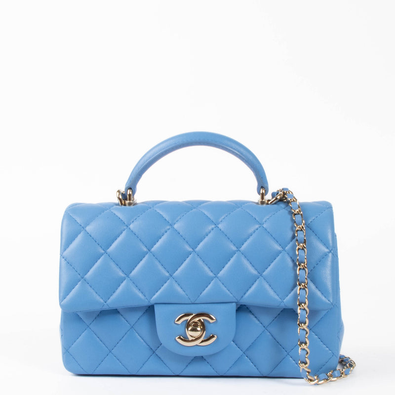 Shop this authentic Chanel Blue Lambskin Mini Flap Bag with Handle pre-loved on Labellov.com
