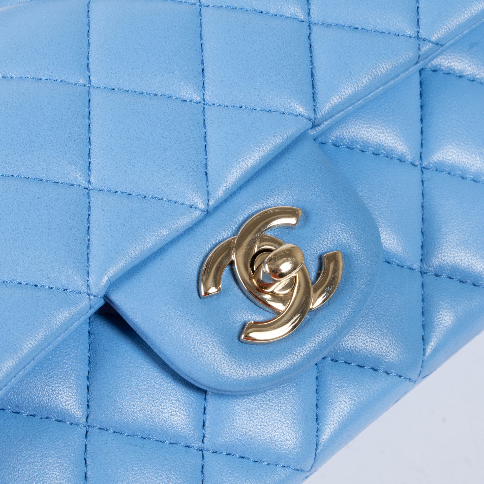 Shop this authentic Chanel Blue Lambskin Mini Flap Bag with Handle pre-loved on Labellov.com