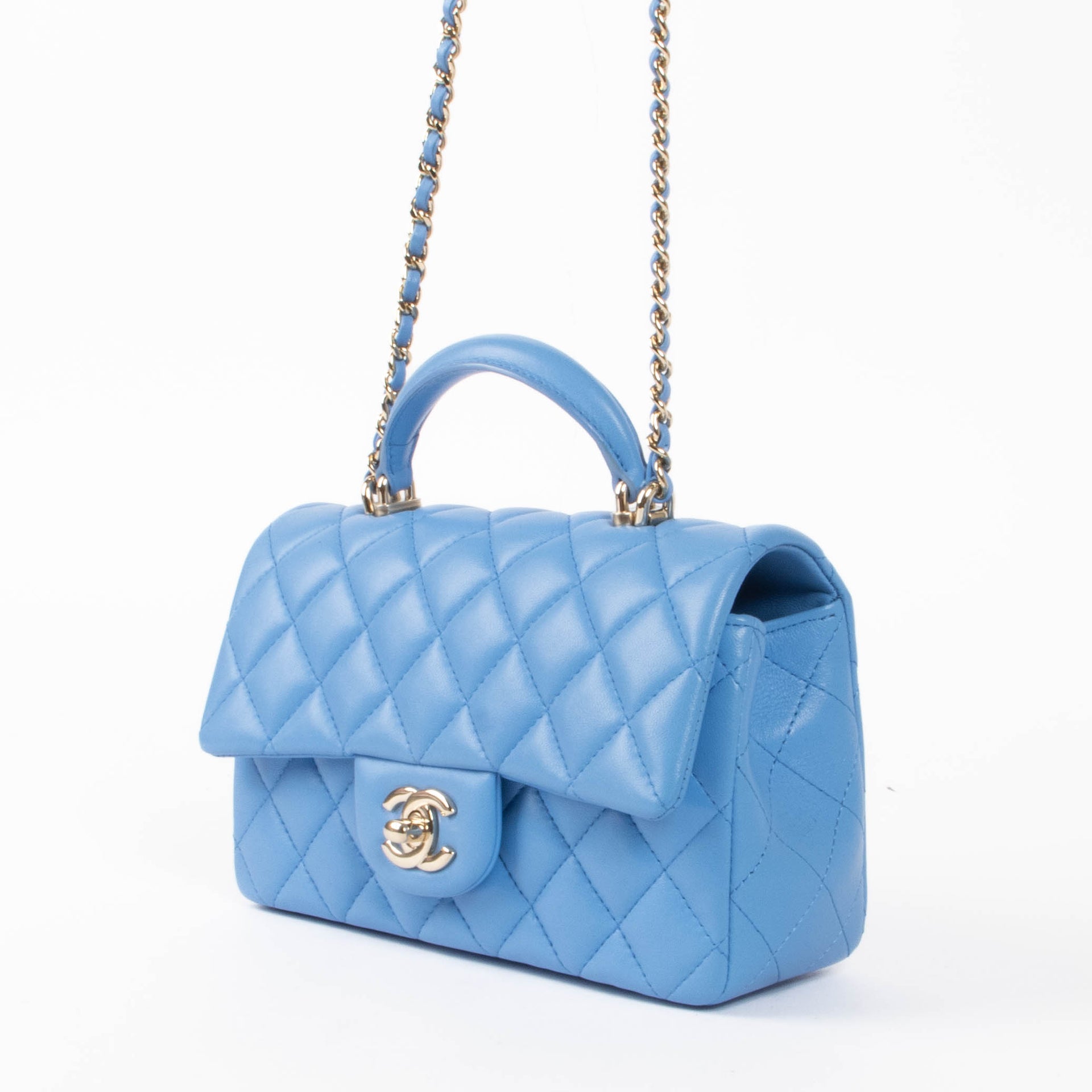 Shop this authentic Chanel Blue Lambskin Mini Flap Bag with Handle pre-loved on Labellov.com