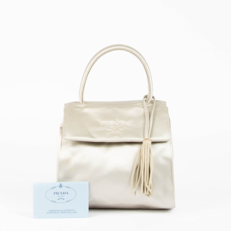 Shop this authentic Prada Silver Satin Top Handle Bag pre-loved on Labellov.com