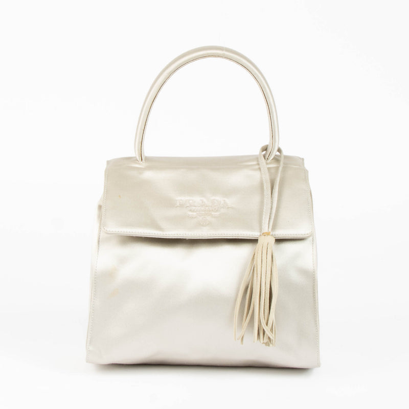 Shop this authentic Prada Silver Satin Top Handle Bag pre-loved on Labellov.com 