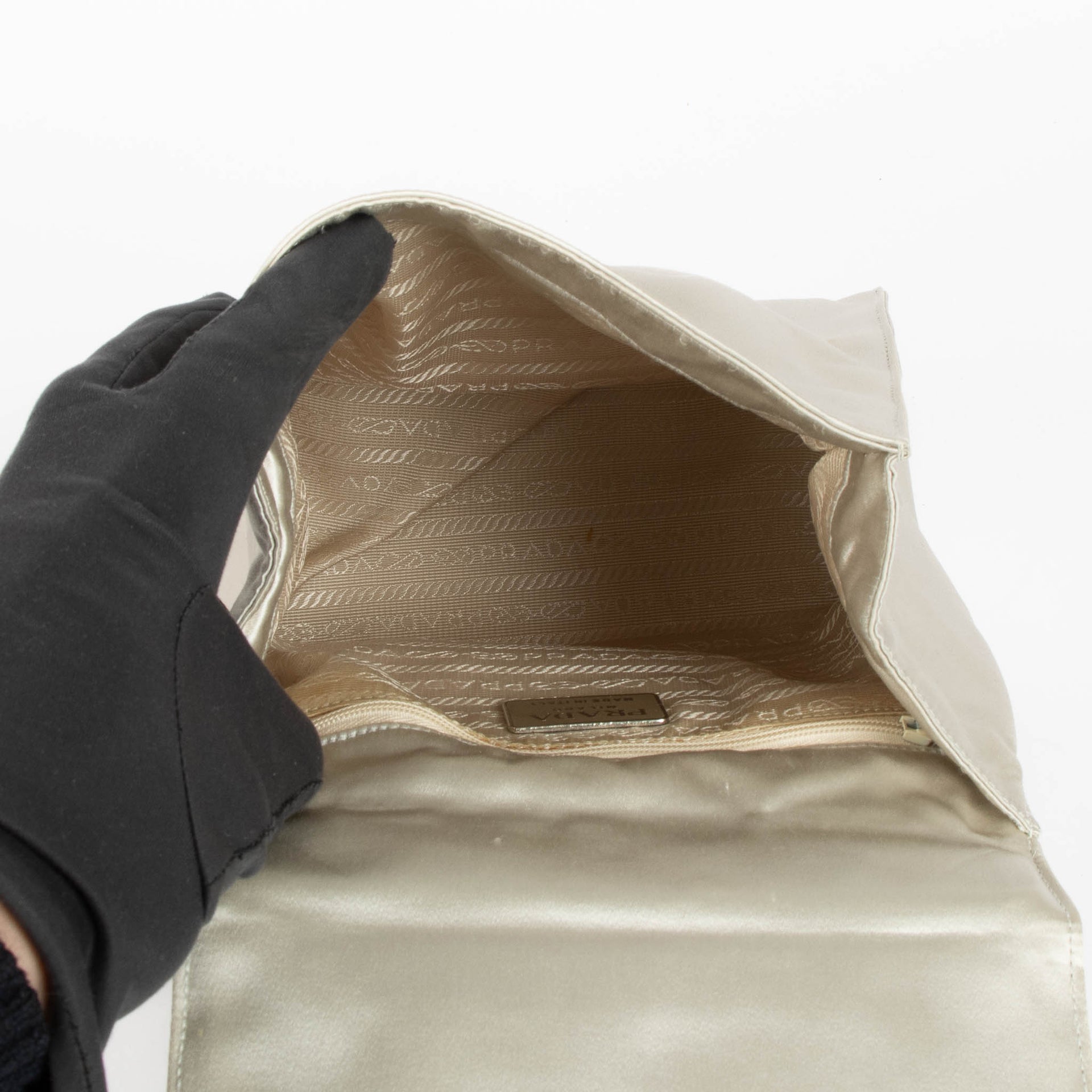 Shop this authentic Prada Silver Satin Top Handle Bag pre-loved on Labellov.com