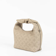 Shop this 100% authentic Louis Vuitton Tourterelle Why Knot Bag at Labellov.com