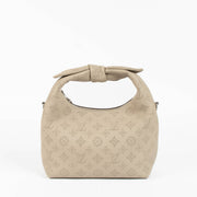 Shop this 100% authentic Louis Vuitton Tourterelle Why Knot Bag at Labellov.com