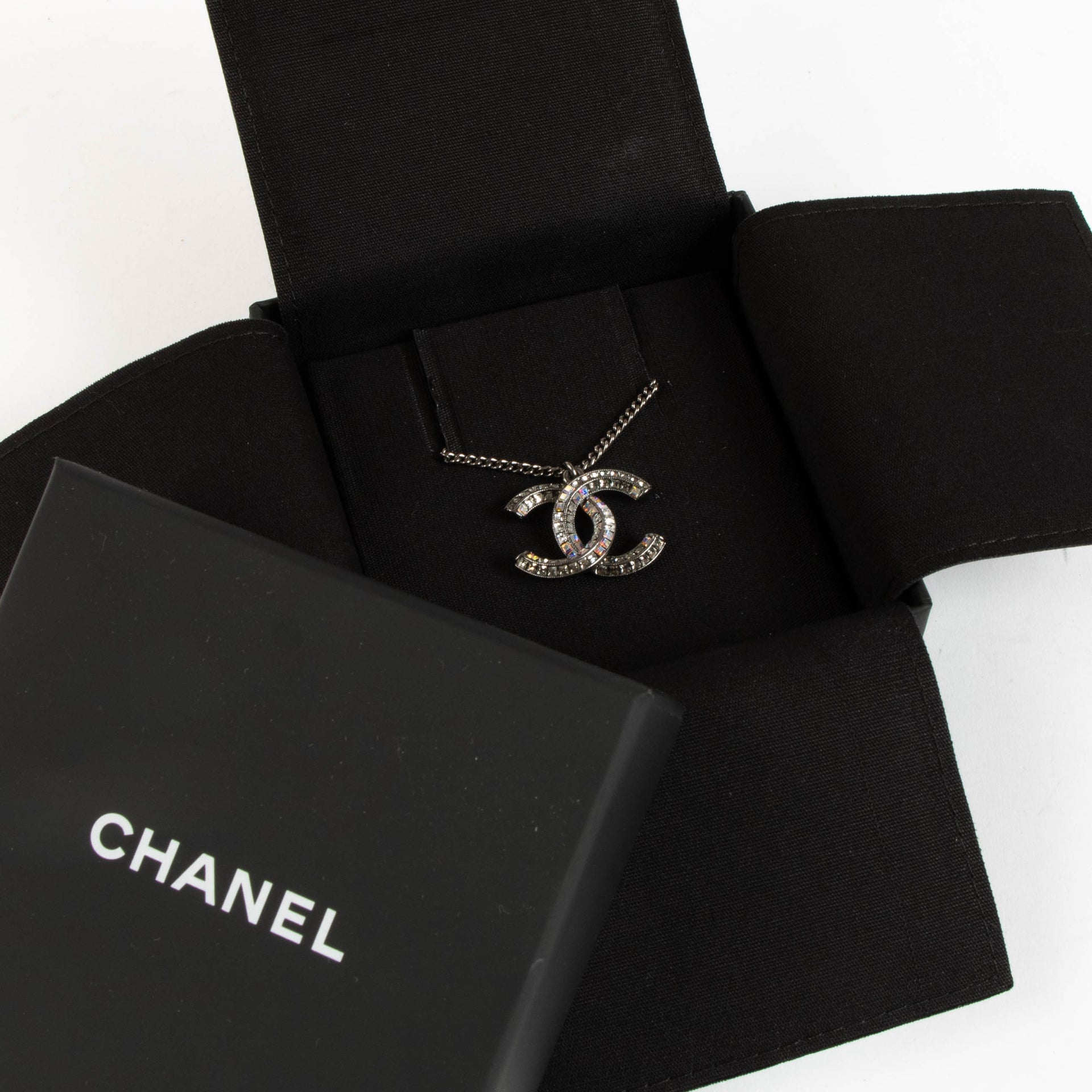 Shop the authentic Chanel Silver 15P Crystal CC Necklace second hand on Labellov.com