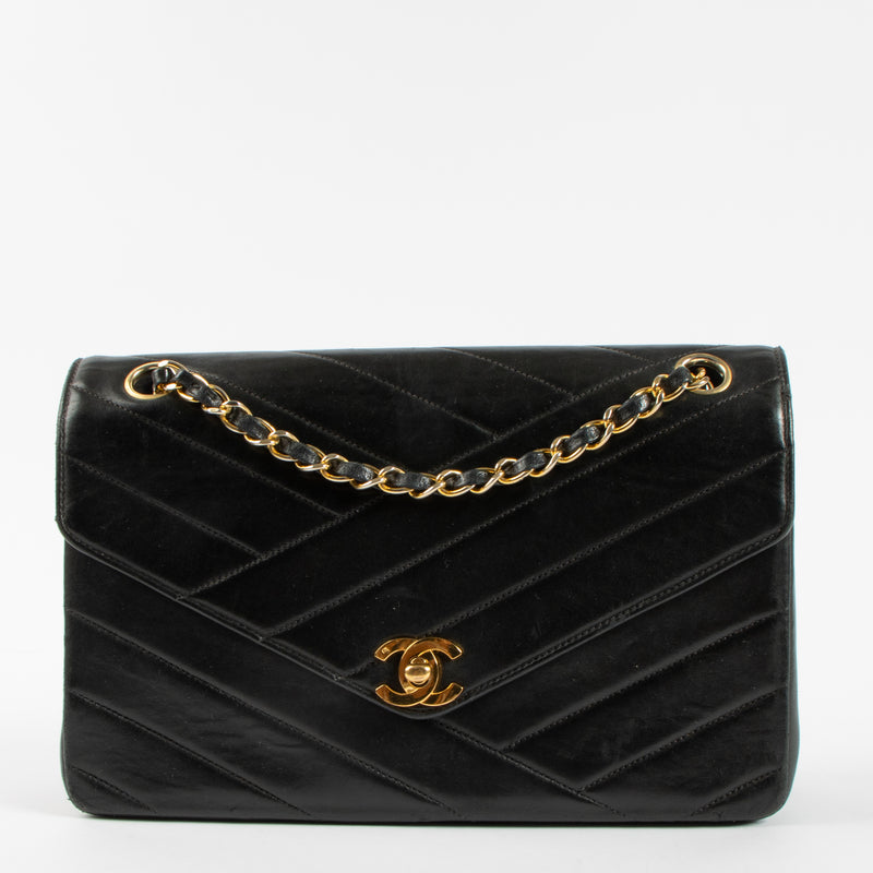Shop the Chanel Vintage Black Lambskin Flap Bag in good condition at Labellov. A timeless vintage Chanel classic with iconic design.
