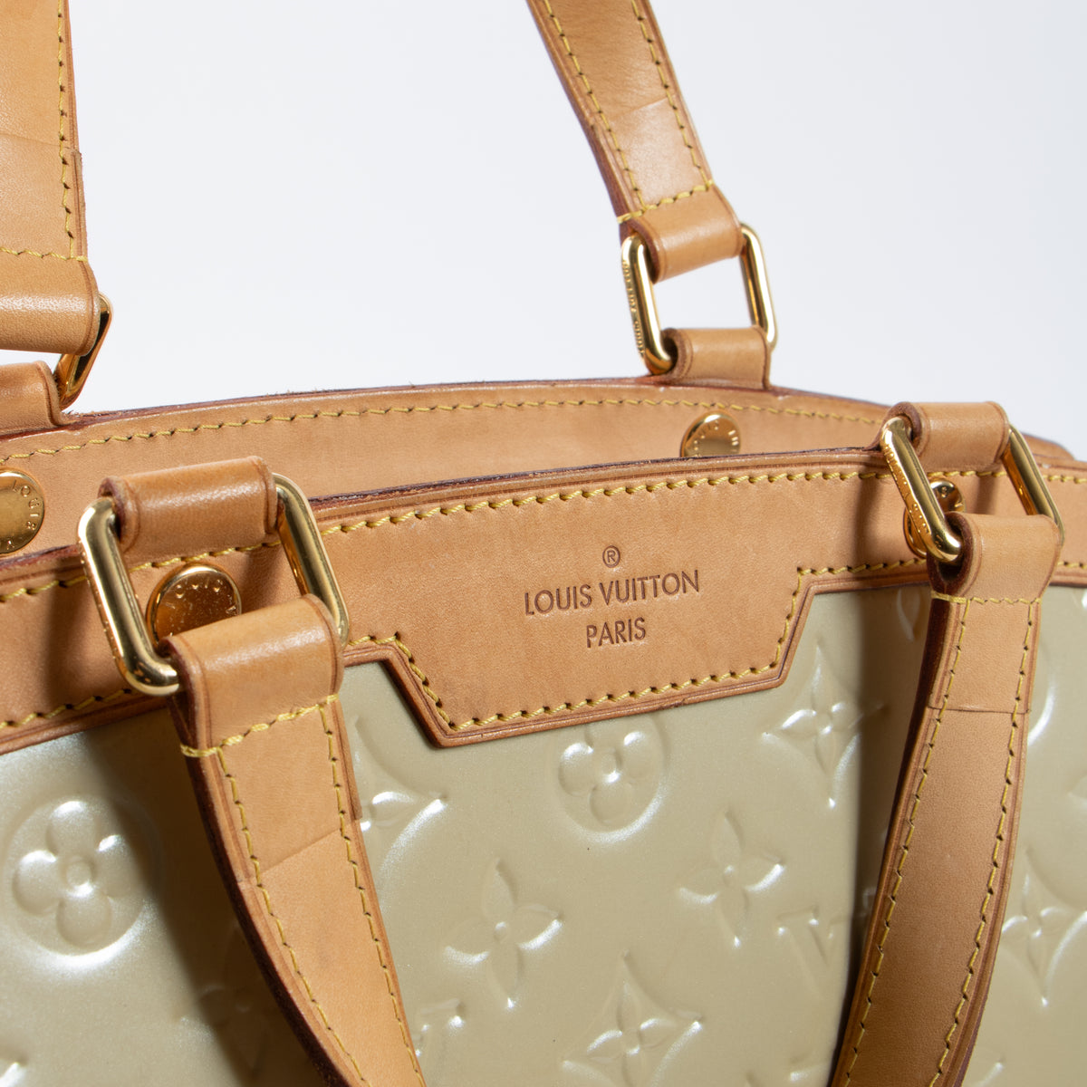 Shop this authentic Louis Vuitton Blanc Corail Monogram Vernis Brea GM Bag pre-loved on Labellov.com