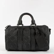 Shop this authentic Louis Vuitton Black Monogram Empreinte Keepall Bandouliere 20 pre-loved on Labellov.com