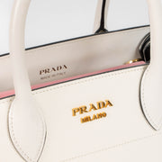 Shop this authentic Prada White/Pink Small Bibliothèque Tote pre-loved on Labellov.com 