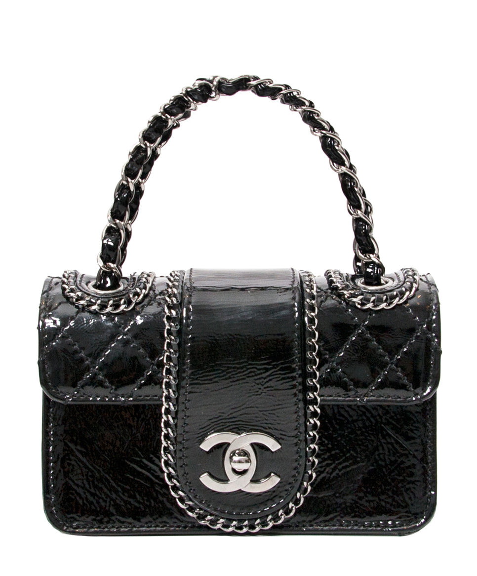 Petite Chanel flap bag with quilted detail and gunmetal chain trimming of the front panel. The back of the bag is entirely quilted patant lambskin. Comes in original dustbag and with authenticity card N°11403855. The bag is either held in hand or when