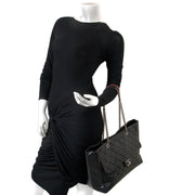Chanel Glazed Calfskin Shopper Flap Tote as worn by a model