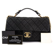 Chanel flap bag with grained black calfskin leather. Gold-toned chanel sign. Online vintage bags at Labellov.