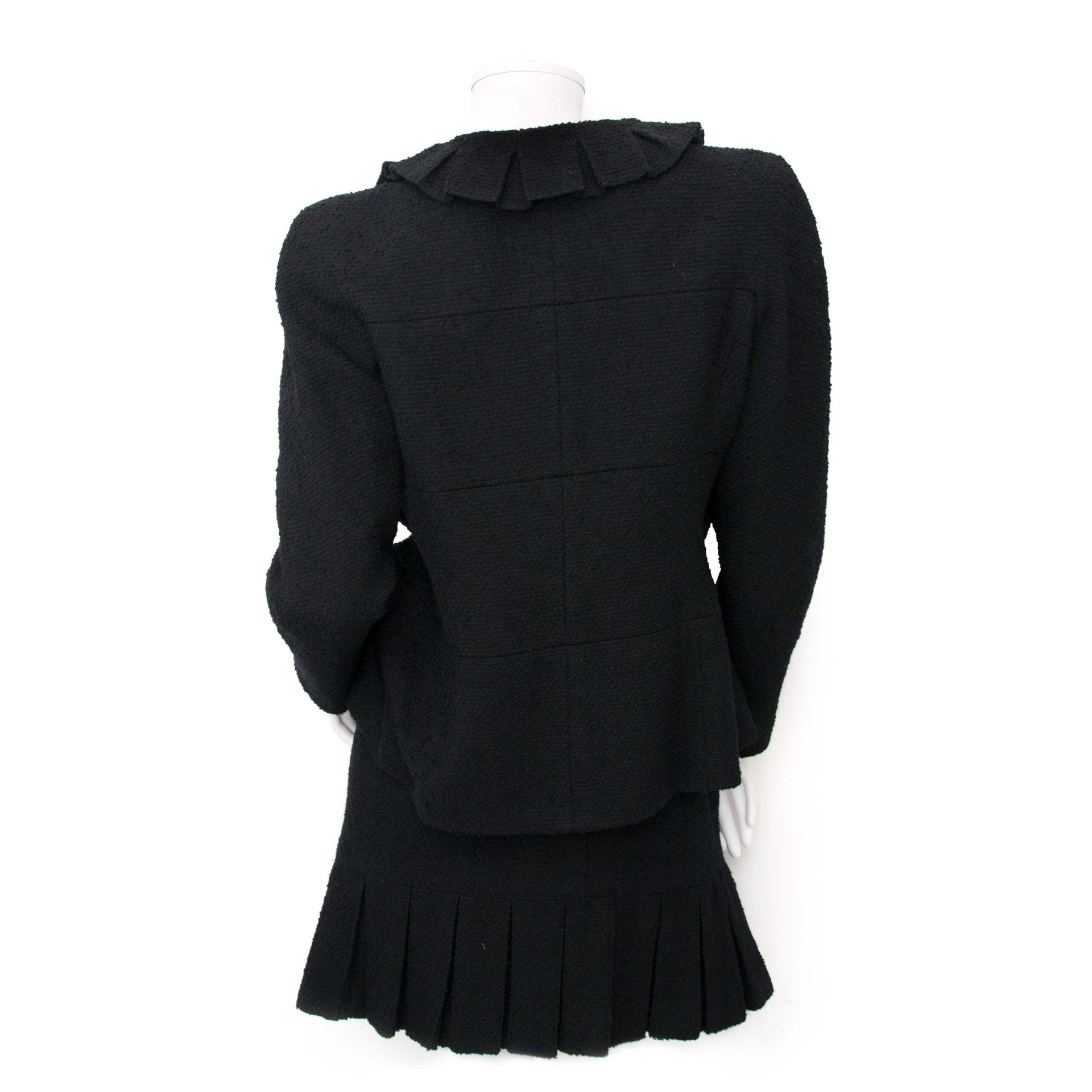 Are you interested in an authentic Chanel Tweed Black Two-Piece with Skirt? Shop yours safely online.