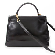 Vintage Hermès Kelly black so black Bag With Shoulder Strap Black Box Calf. Buy online or in the Labellov Boutique Antwerp, Belgium. Labellov is een tweedehands winkel in Antwerpen, België. Seconde main et occasion vintage boutique a Anvers, Belgique.