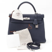 Brand new, storebought Hermès Kelly bag 32 in beautiful 'Blue Nuit' or midnight blue - a deep, rich dark blue hue - in Taurillon Clemence leather. Has paladium hardware and comes with clochet cadenas keyholder and padlock. Blindstamp 'T' , 2015. Comes