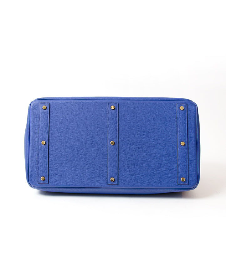 This particular HAC was recently made in exquisite Togo leather in an electrifying blue hue. Blindstamp: R is a square Gold-tone hardware Comes in the original box, with rain jacket, dustbag and clochette cadenas.