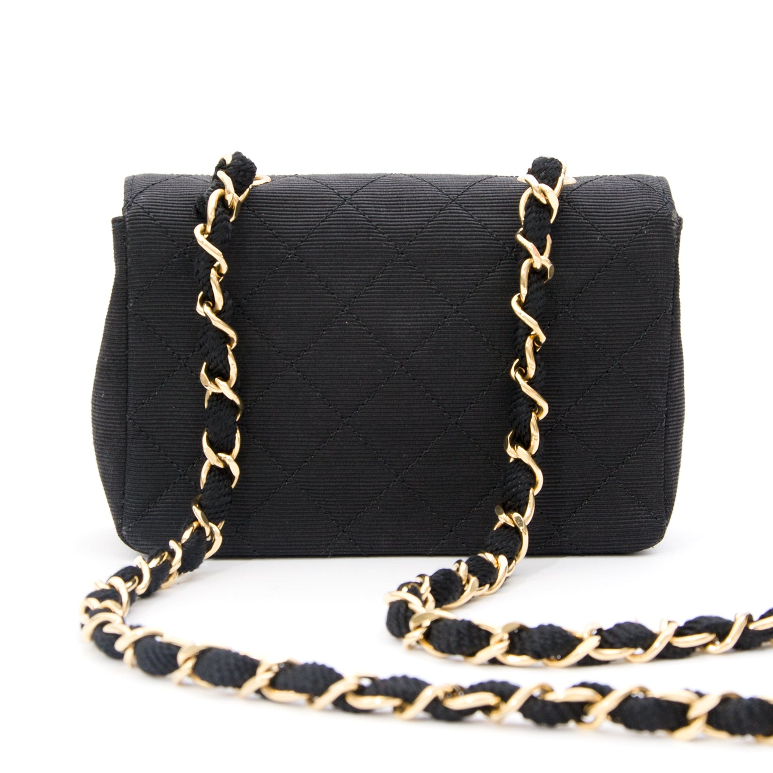 Chanel Silk Evening Purse On A Chain Mini Chanel flap bag made from quilted silk with long gold-tone and silk entwined shoulder strap.