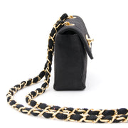 Mini Chanel flap bag made from quilted silk with long gold-tone and silk entwined shoulder strap.
