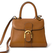 Delvaux Brillant Grained Cognac PM + Strap Delvaux Cognac Brillant in distinctive grained leather. This beautiful Brillant bag from Delvaux is a timeless piece which you can wear every season. The bag has a tophandle and a detachable shoulderstrap so you