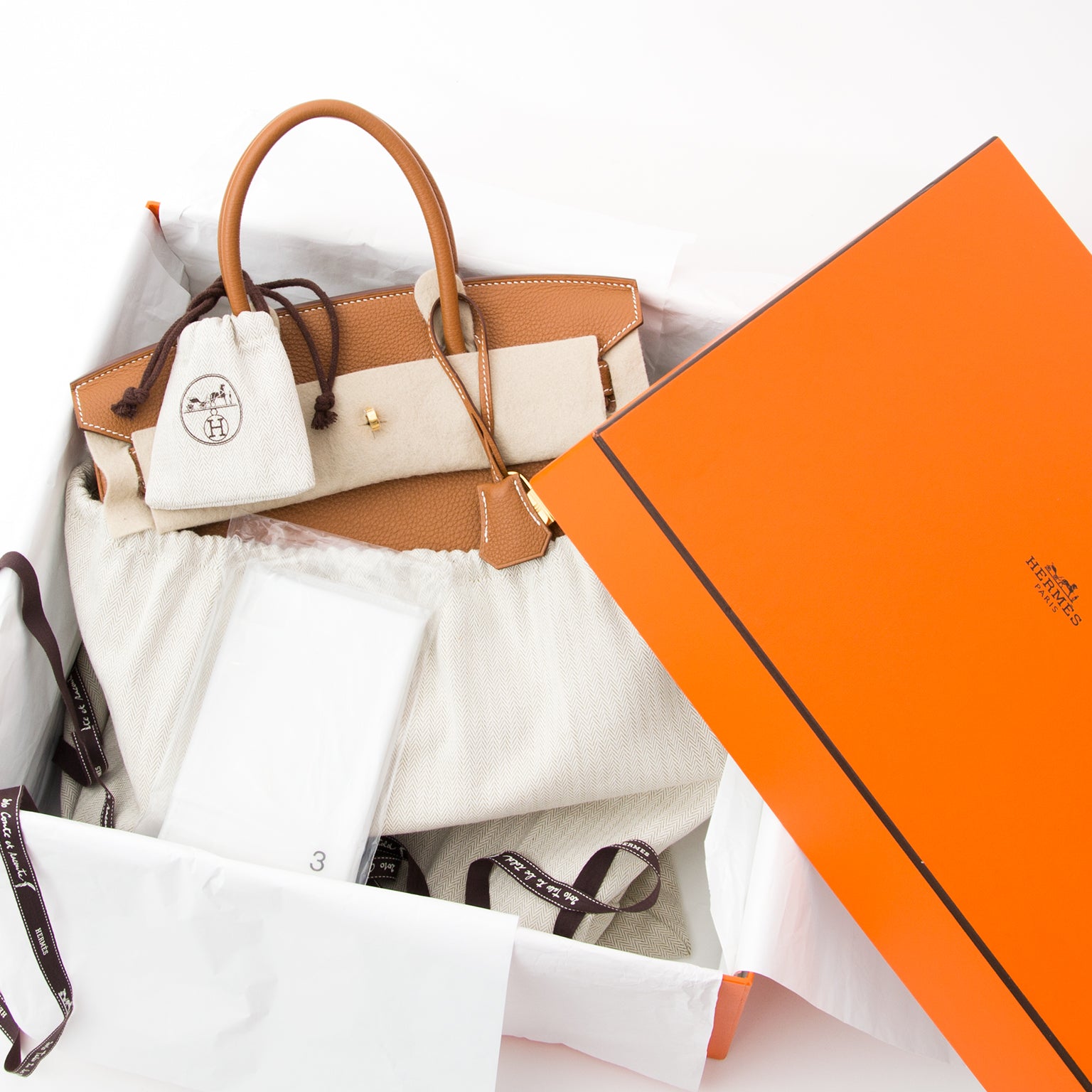 Fresh from the Hermès store, this is the famous Birkin tote in 'Gold' - cognac - Togo leather. Gold-tone hardware. Blindstamp : N in a square Hardware protective plastic seals still present. Comes in original box with sudtbag, rainjacket, clochet
