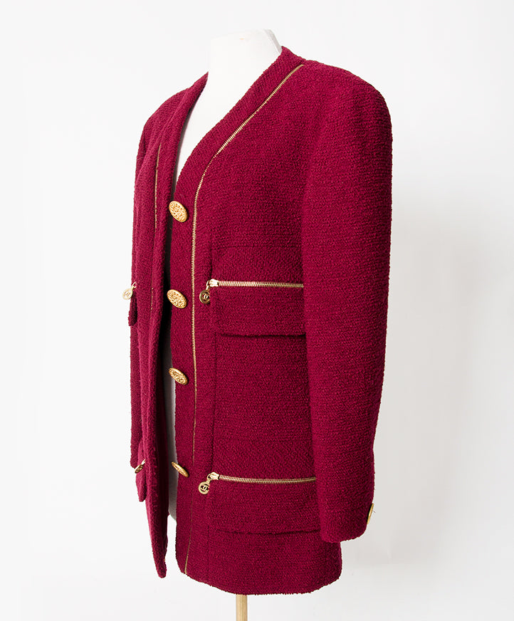 Chanel Burgundy Wool Zipper Jacket. Absolutely stunning Chanel Boutique jacket in signature bouclé wool with golden zippers and buttons. Fully lined with logo embroidered silk and finished with gold chain in hem line. Can be worn as a slightly oversized w