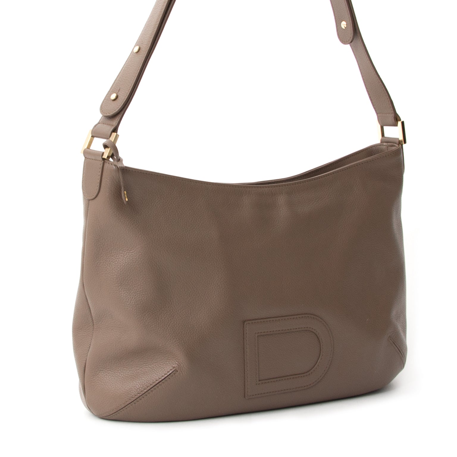 A lovely Delvaux hobo bag with signature 'D' logo stitched application. The gold-tone hardware matches the smooth taupe calfskin beautifully. The leather feels smooth to the touch and has a slight shine. Gorgeous simplicity for everyday wear and to any o