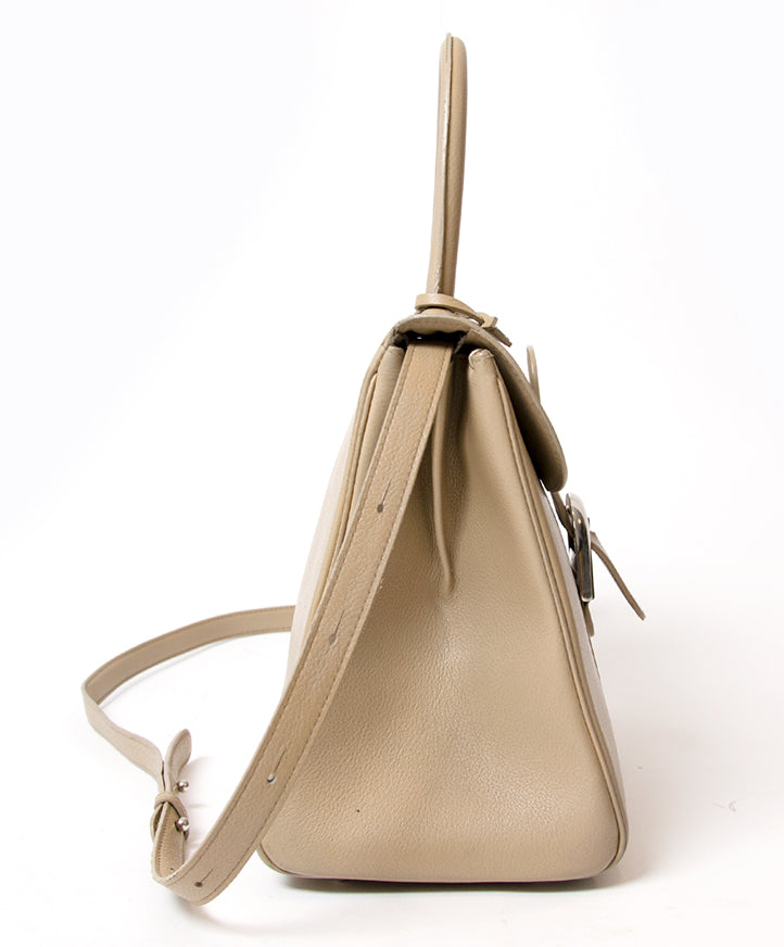 This Delvaux Brillant MM is a top handle bag with attachable shoulder strap in 'Plume' or greige colored 'Jumping' type calfskin. Gold hardware throughout.