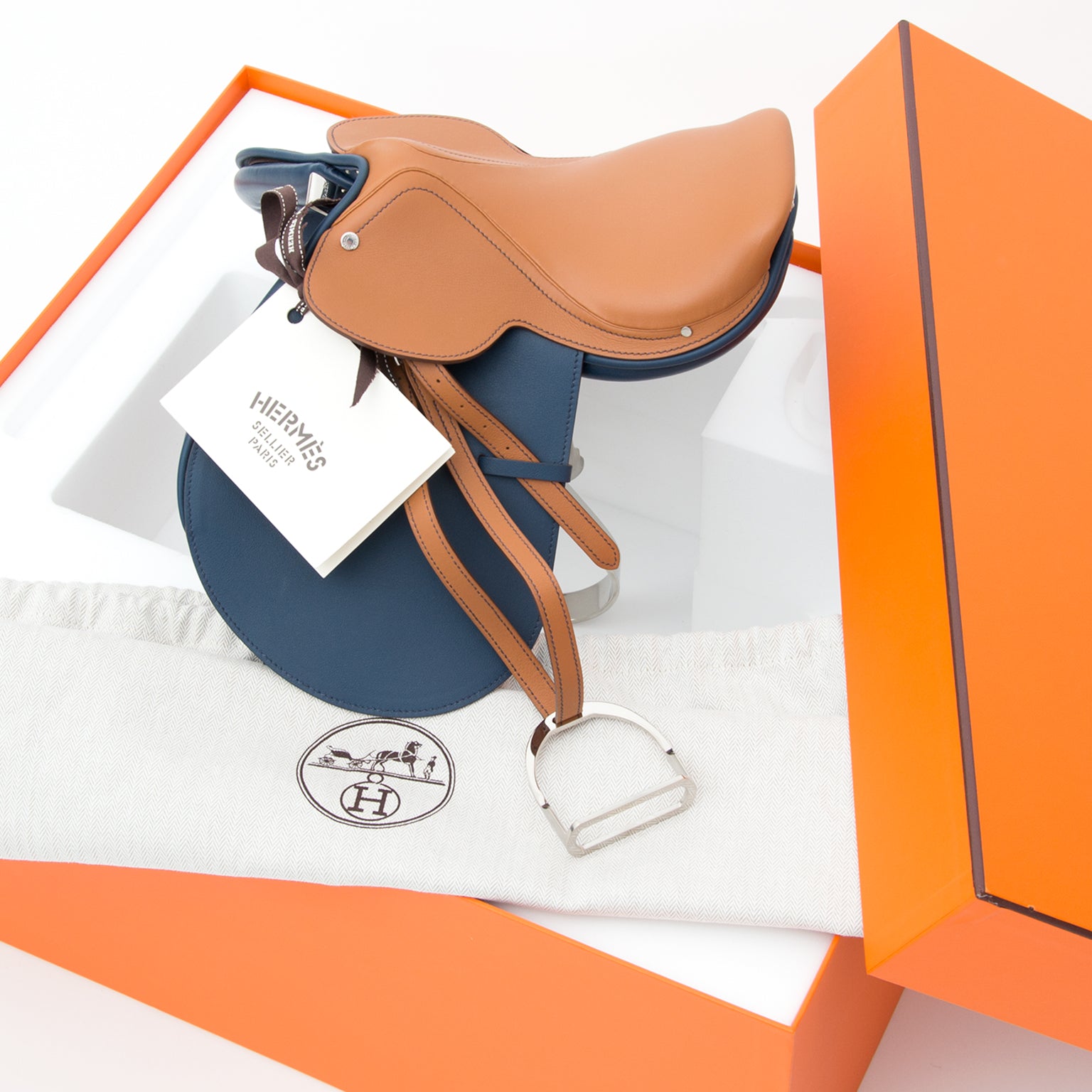 Hermes Steinkraus mini saddle statue with Hermes in Gold and Blue De Prusse calfskin seat, stirrups and stirrup leathers. this particular edition is quite rare and sought after because of the two colors.