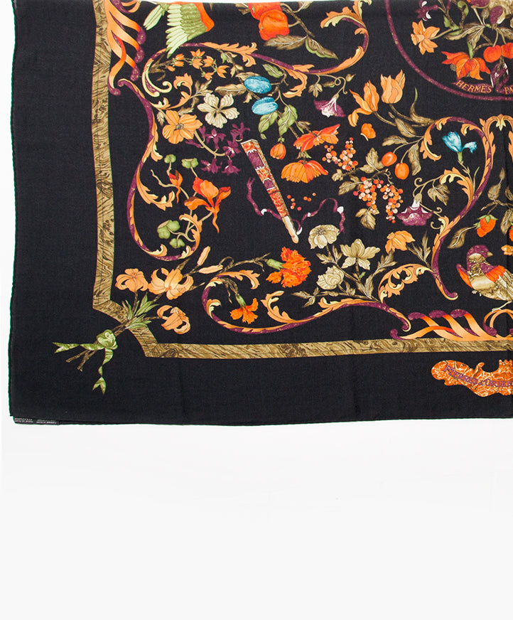 Large 35% silk and 65% cashmere blend scarf by Herùès, titled 'Pierre D'Orient Et D'Occident', signed 'Zoé'. Black backdrop with vibrant orange and blue hues. Perfect large and warm scarf for Fall.