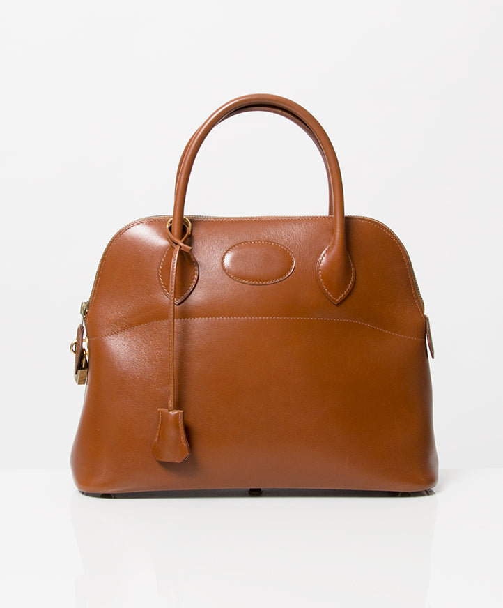 Vintage Hermès Bolide 32 Cognac Box Calf Tote Bag. Buy authentic secondhand Hermès bags at the right price at LabelLOV webshop. Safe and secure online shopping. Koop authentieke tweedehands Hermès tassen met de juiste prijs bij LabelLOV.