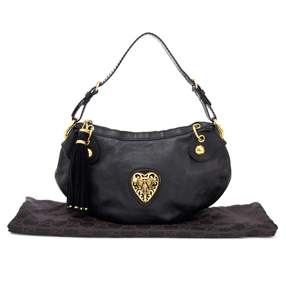 Buy Gucci Black Babushka shoulder bag with golden heart at the right price at LabelLOV vintage webshop. Luxe, vintage, fashion. Safe and secure online shopping. Antwerp, Belgium.
