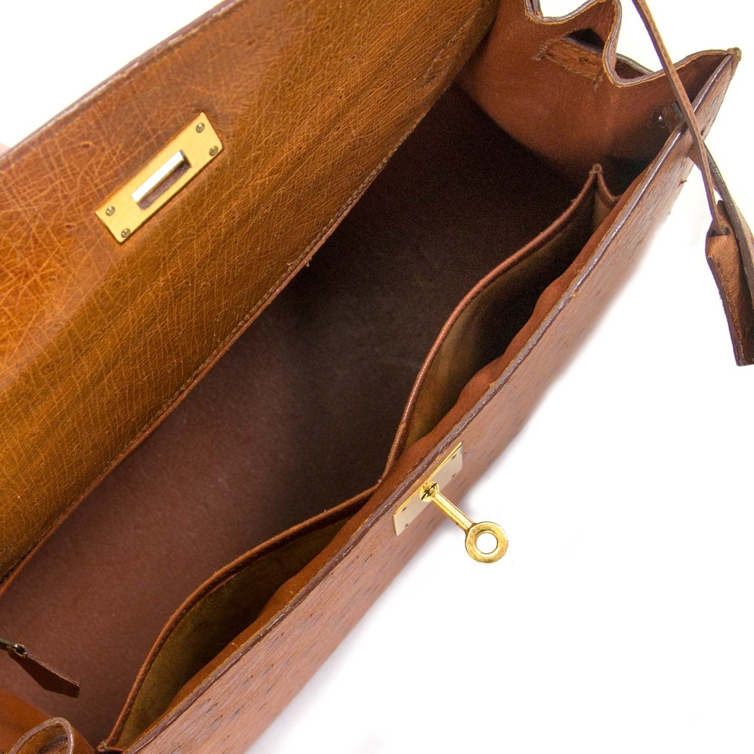 The inside of a luxurious Hermès Kelly Ostrich 32 GHW is very spacious and in good condition