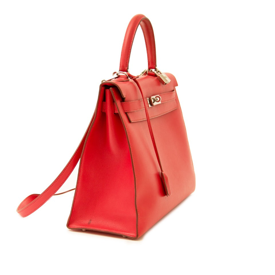 Buy vintage Hermes Kelly 35 Bougainvillea Red Swift PHW with strap at the right price at LabelLOV vintage webshop. Luxe, vintage, fashion. Safe and secure online shopping. Antwerp, Belgium.