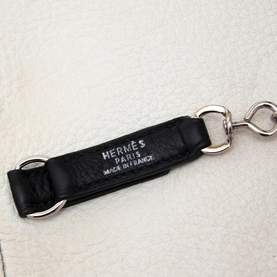 Buy Brand New Hermes white plume bag with black trim at the right price at LabelLOV vintage webshop. Luxe, vintage, fashion. Safe and secure online shopping. Antwerp, Belgium.