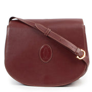 Op een veilige manier online kopen van een Cartier De must crossbody handtas in burgundy leer.