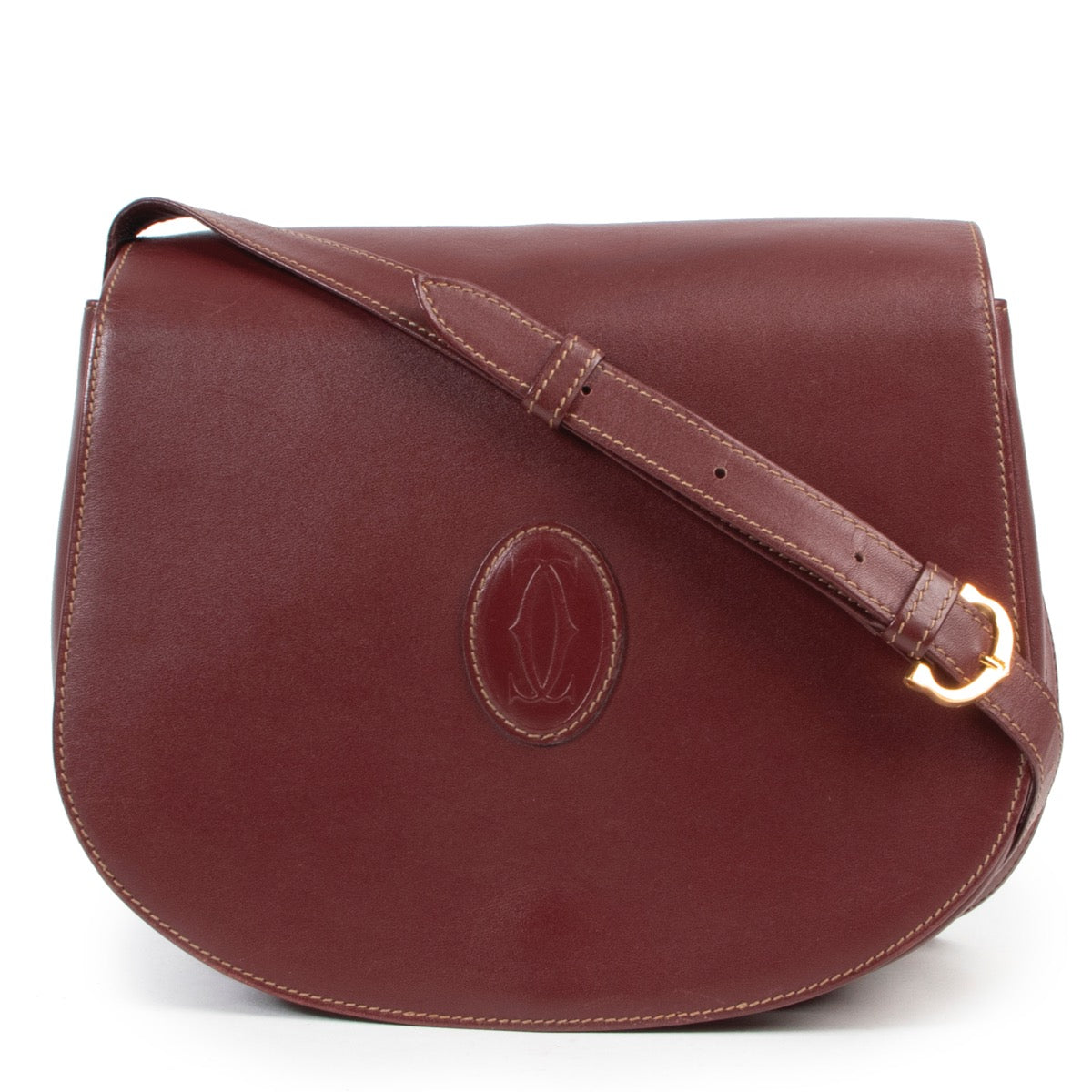 Op een veilige manier online kopen van een Cartier De must crossbody handtas in burgundy leer.