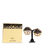 Veilige online kopen van Moschino clip oorbellen in verguld goud.