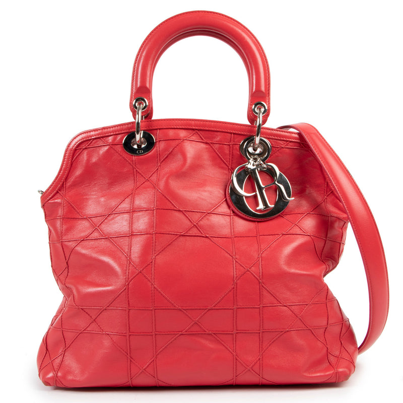 Christian Dior Dark Pink Cannage Quilted Lambskin Shoulder Bag All of the iconic features of the classic Dior IT-Bag 'Lady Dior' combined into a contemporary tote - this Christian Dior Dark Pink Cannage Quilted Lambskin Shoulder Bag is a must-have for