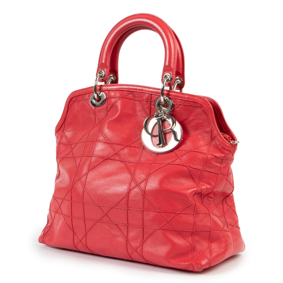 Christian Dior Dark Pink Cannage Quilted Lambskin Shoulder Bag All of the iconic features of the classic Dior IT-Bag 'Lady Dior' combined into a contemporary tote - this Christian Dior Dark Pink Cannage Quilted Lambskin Shoulder Bag is a must-have for