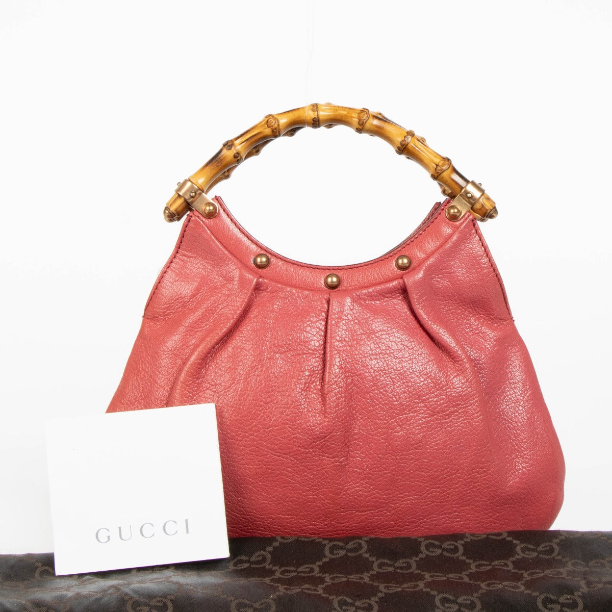 Shop this 100% authentic Gucci Pink Pebbled Leather Bamboo Handle Hobo Bag at labellov.com.