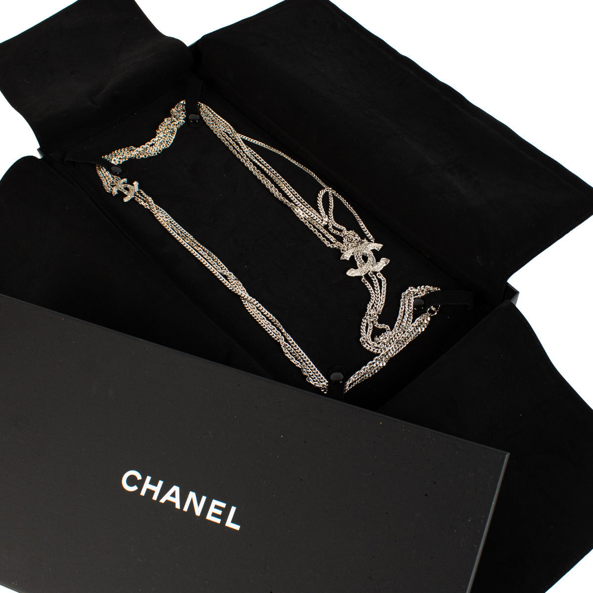 Elevate your style with the timeless elegance of the Chanel Silver CC Crystal Necklace. This stunning piece features the iconic double 'CC' logo, encrusted with dazzling crystals that catch the light with every movement. Crafted from high-quality silver-t