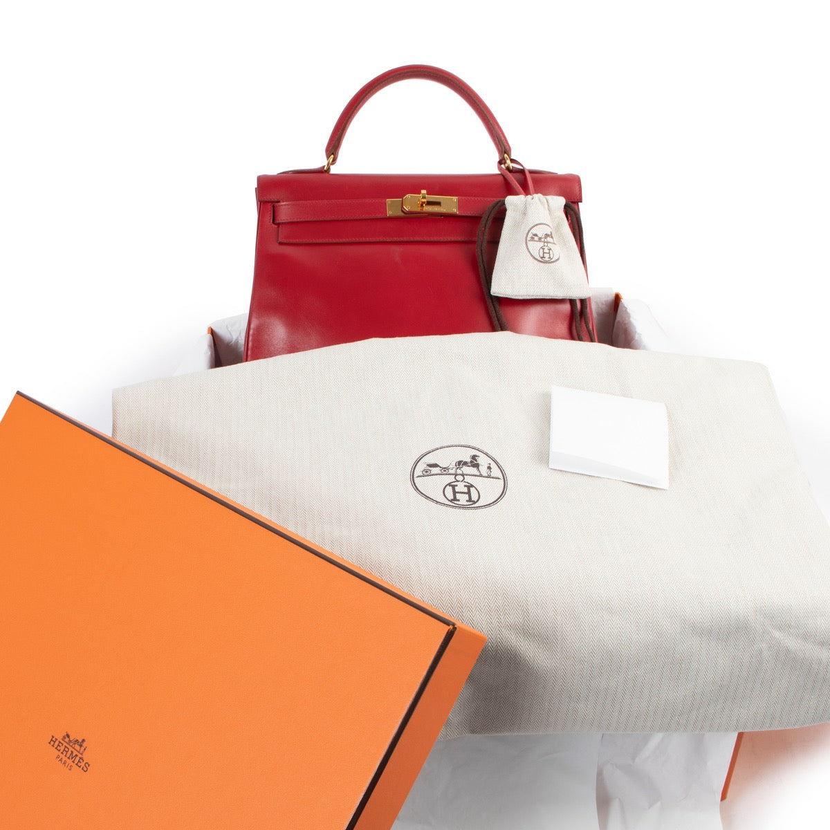 Shop safe online 100% authentic second hand Hermès Kelly Retourne 32 Smooth Red Veau Tadelakt Calfskin GHW at Labellov in Antwerp.