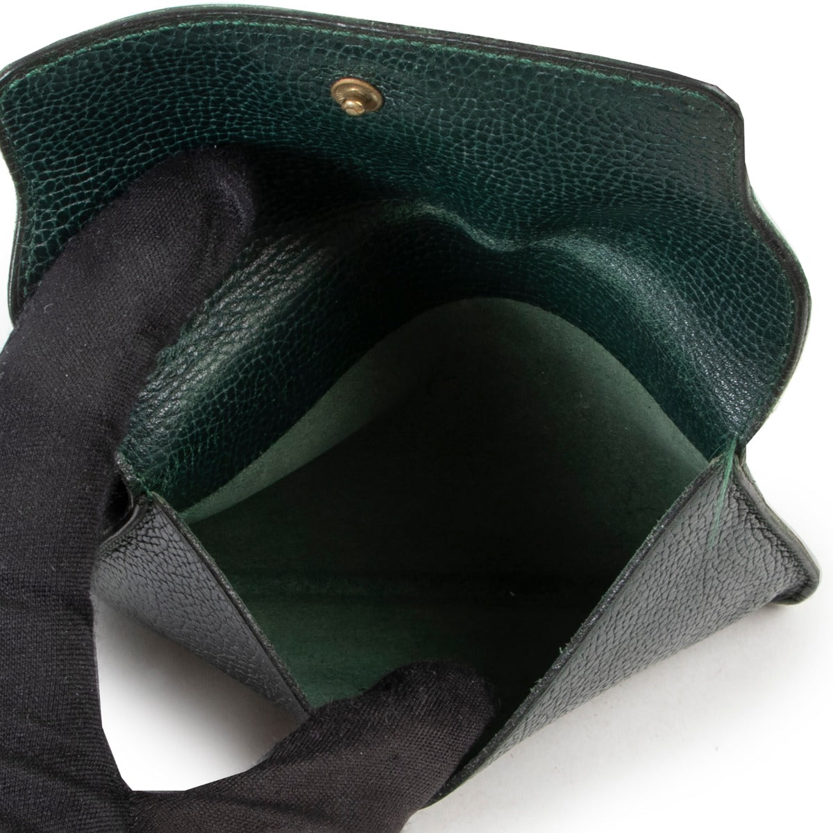 Online website in green leather wallet by Delvaux with gold D initial