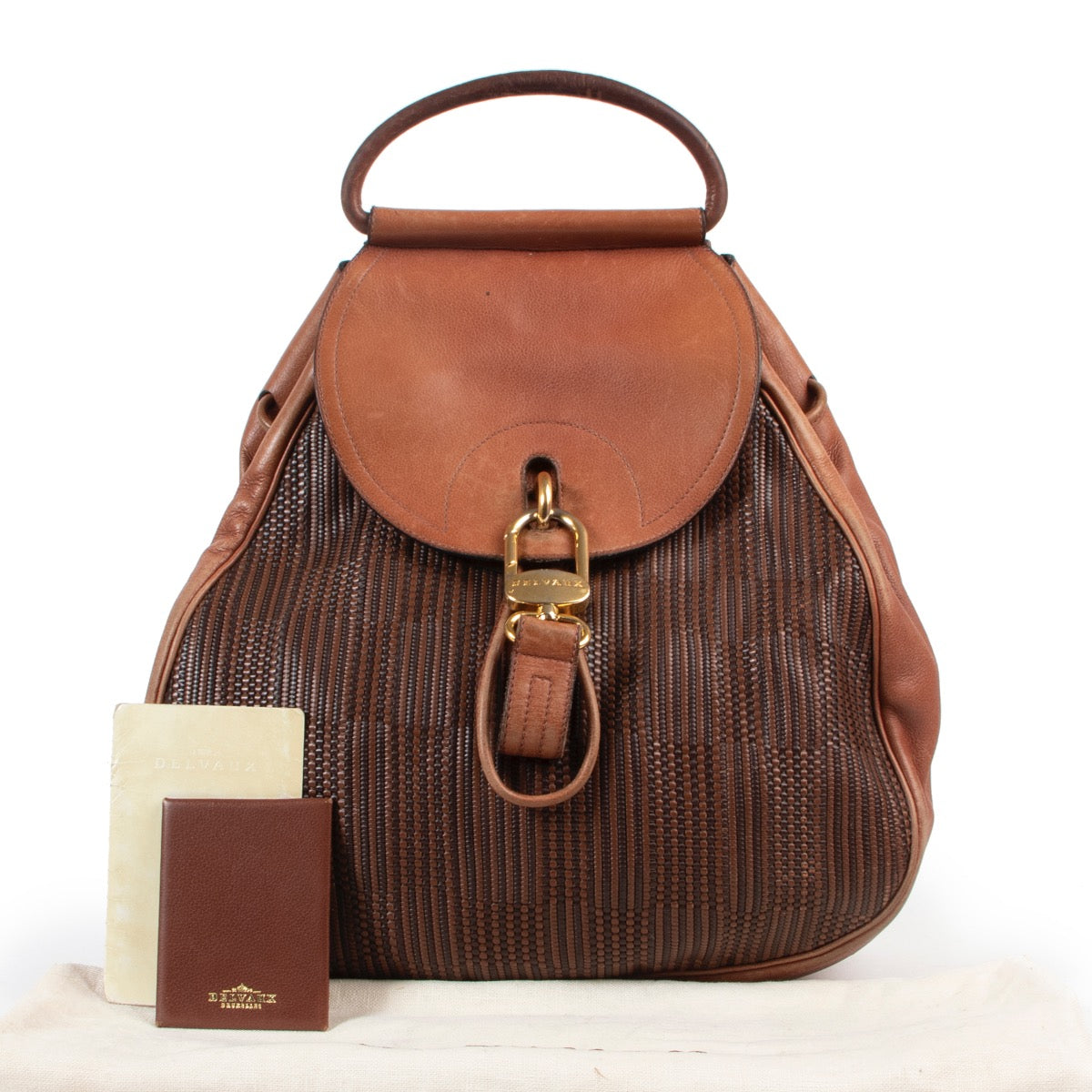 Koop authentieke tweedehands Delvaux bruin lederen handtas met juiste prijs. Achetez un authentique sac Delvaux en cuir Brun d'occasion au juste prix. Buy authentic second hand Delvaux Cognac Toile De Cuir Backpack bag at the right price.