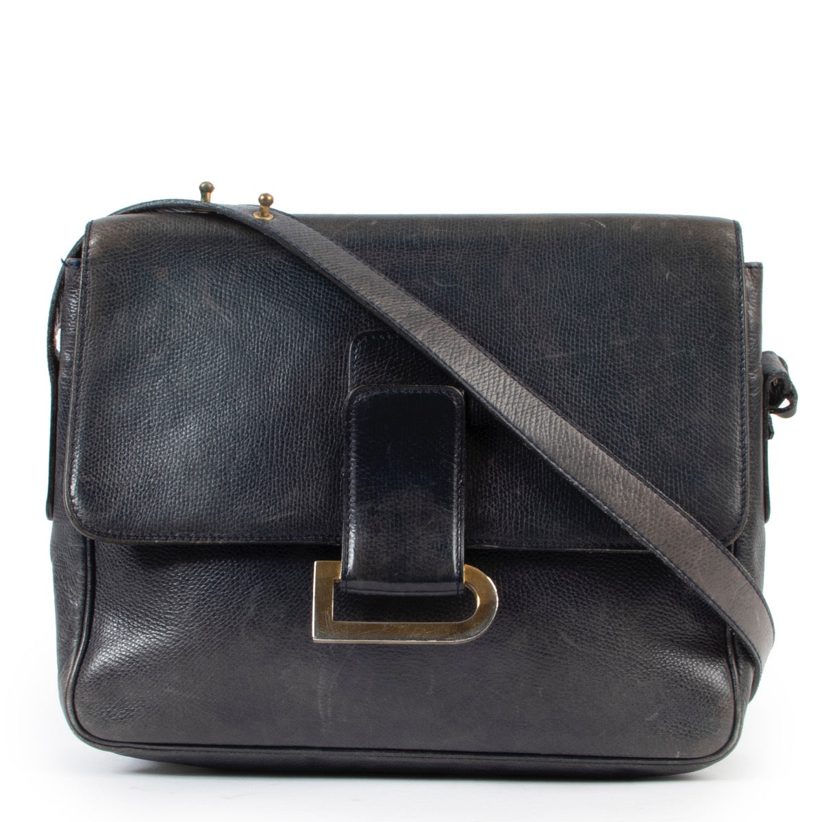 Delvaux Blue Poirier Crossbody Bag We absolutely adore this Poirer handbag. Designed by Delvaux, the oldest fine leather goods house in the world. The handbag is crafted in dark blue leather and finished with a gold toned D in the front. The front f