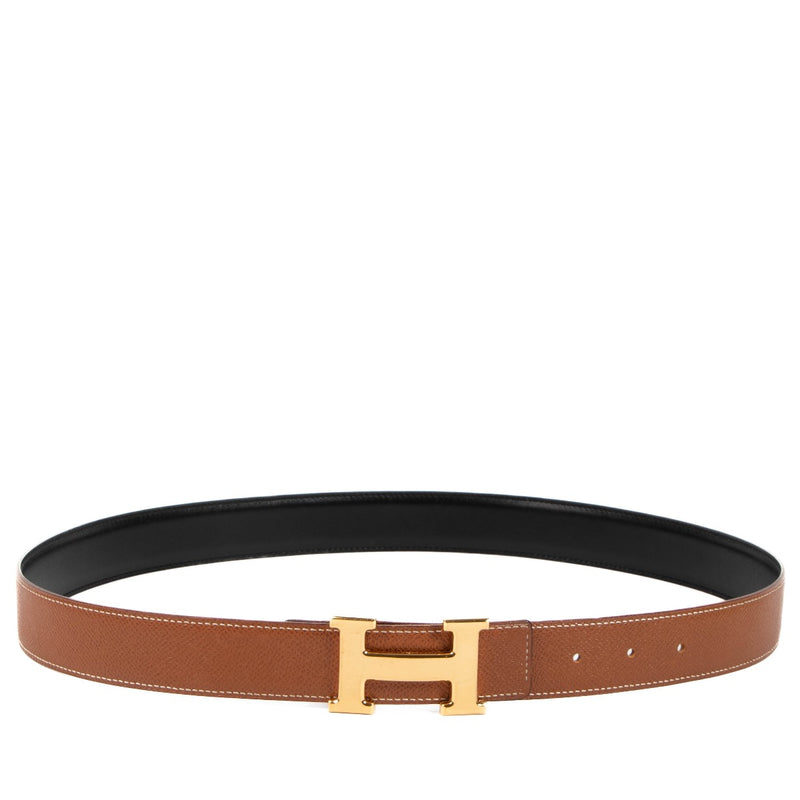 Buy an authentic second hand Hermès black/gold reversible Constance belt in very good condition at Labellov in Antwerp, Knokke, Brussels.