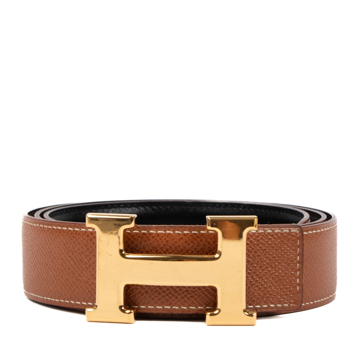 Buy an authentic second hand Hermès black/gold reversible Constance belt in very good condition at Labellov in Antwerp, Knokke, Brussels.