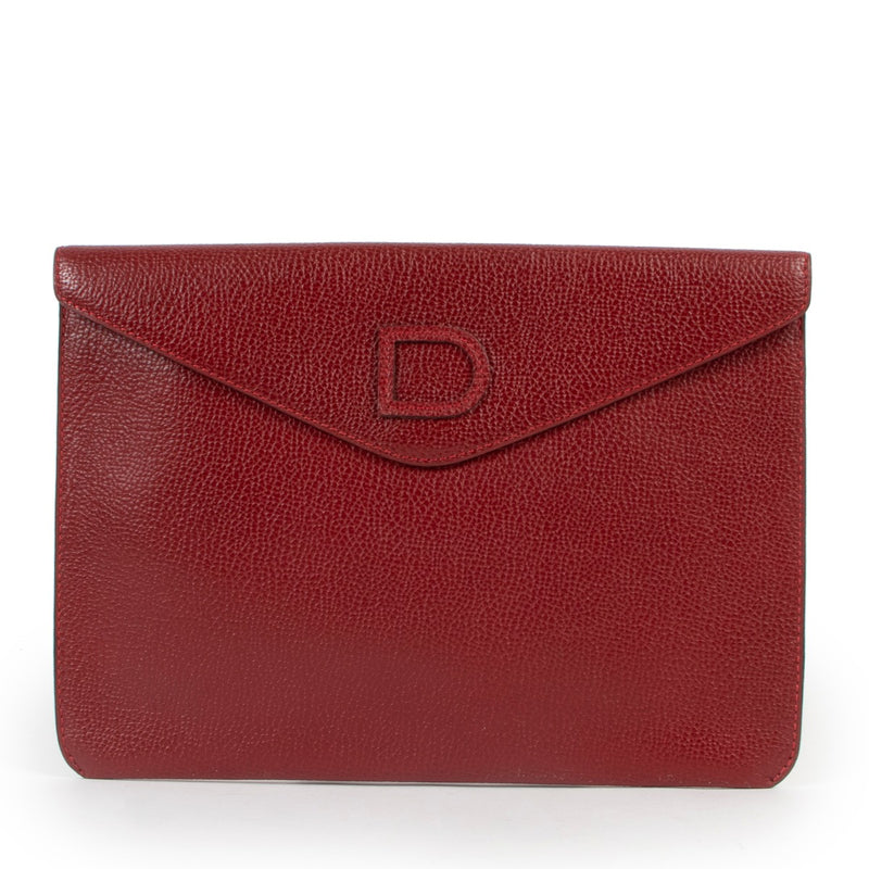 Red leather clutch by Delvaux in good condition