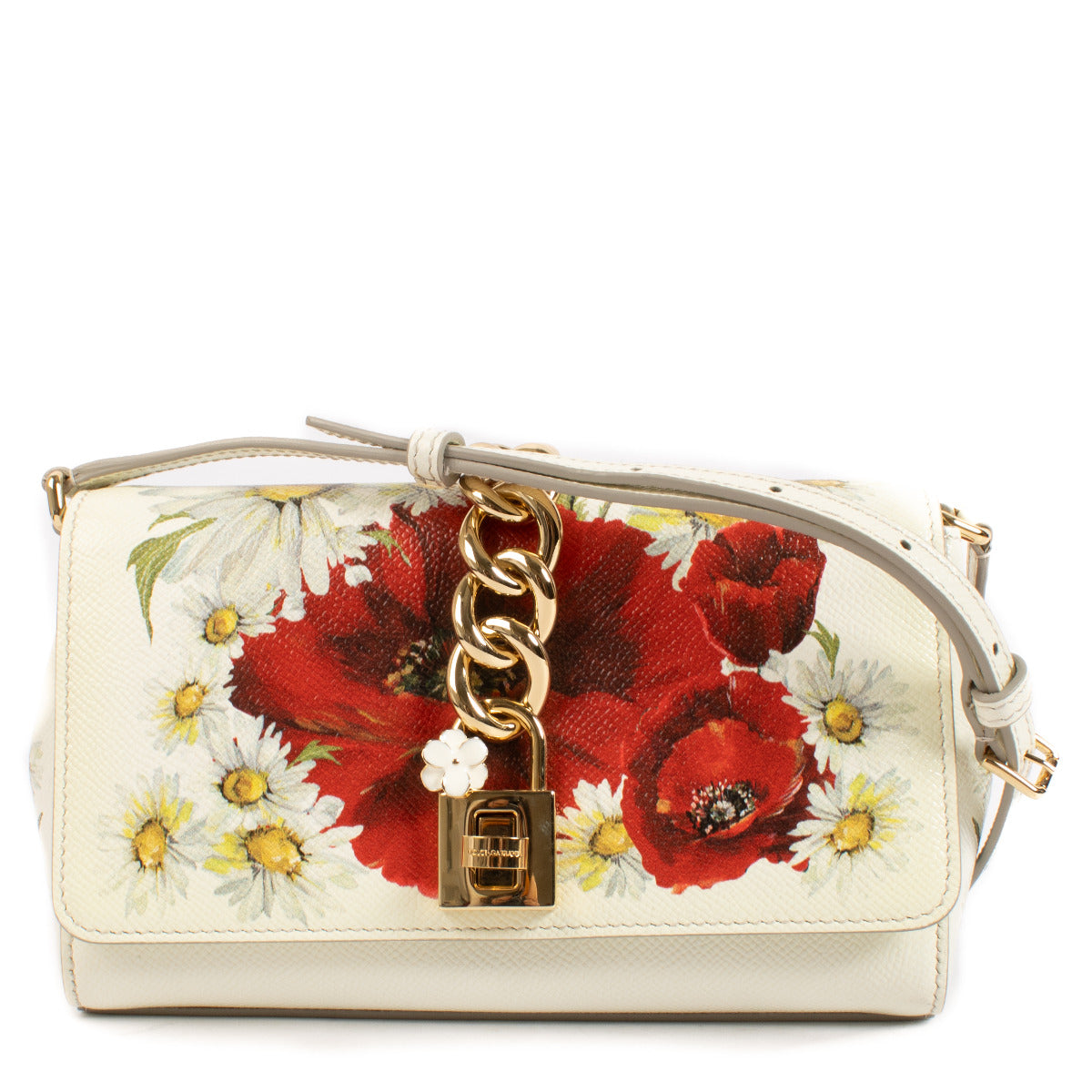 The Dolce & Gabbana Floral Dolce Bag is a celebration of romance and artistry. Adorned with a vibrant floral print, this exquisite bag captures the brand's signature Italian charm. Crafted from premium materials, it features a structured silhouette, a top