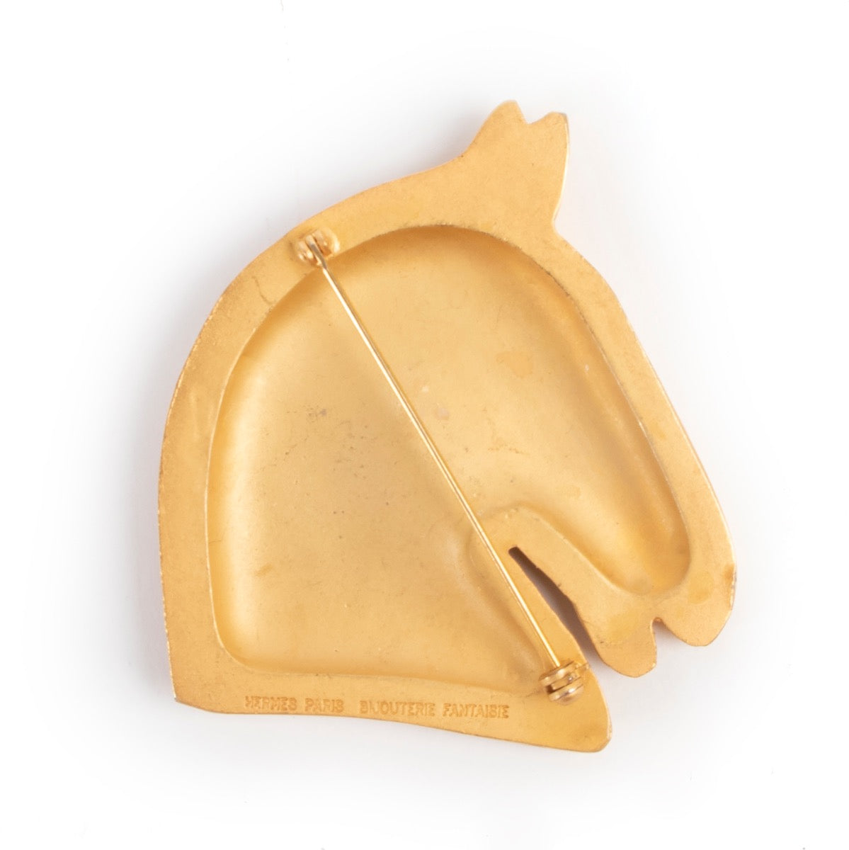 By an authentic second hand Hermès Horse Head Brooch at Labellov